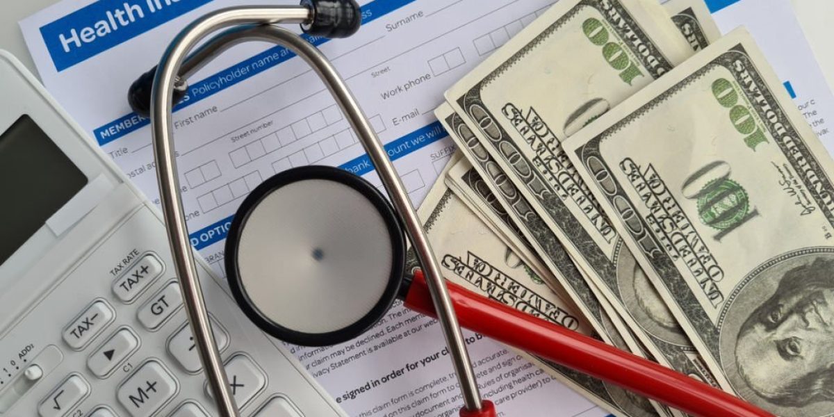 Medical reimbursement with health insurance claim form and stethoscope with money dollars. Health care and modern medicine concept